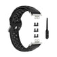 Black perforated silicone watch strap with clasp, replacement adapters, and pin tool.
