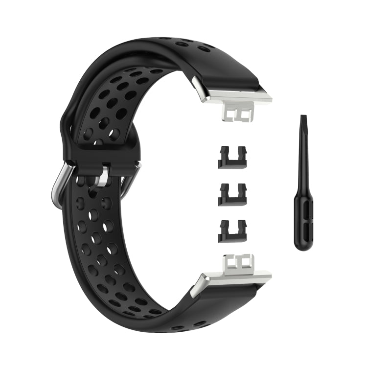 Black perforated silicone watch strap with clasp, replacement adapters, and pin tool.