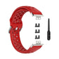 Red perforated silicone watch strap with clasp, replacement adapters, and pin tool.