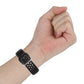 Black perforated silicone watch strap on wrist with metal buckle