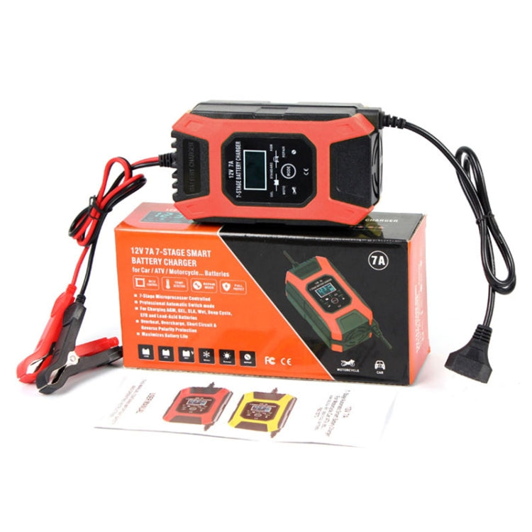 Orange 12V battery charger, showing front control panel, with packaging and accessories