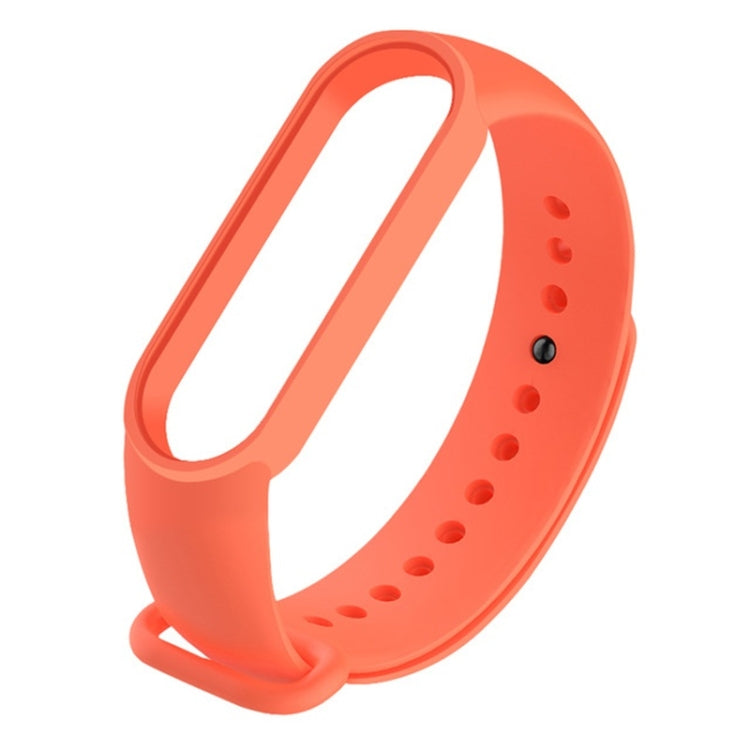 Orange silicone replacement watch strap with adjustable holes and clasp.