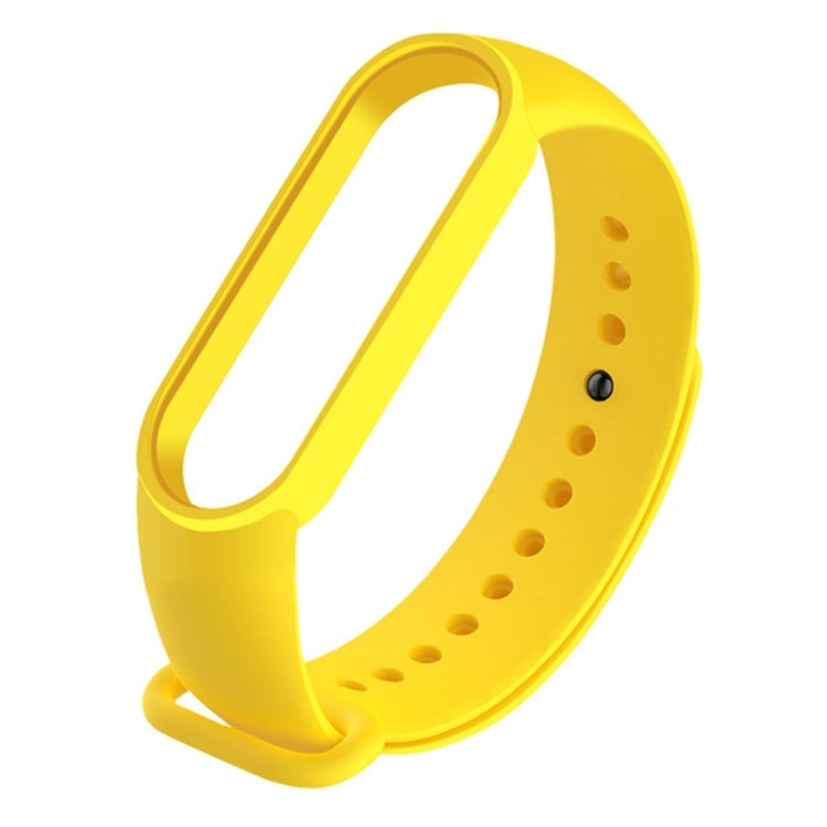 Yellow silicone replacement watch strap with adjustable holes and clasp.
