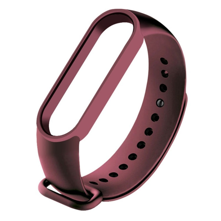 Wine red silicone replacement watch strap with adjustable holes and clasp.