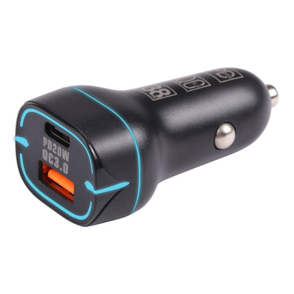 Black dual-port USB car charger with blue illuminated ring and metal plug prongs