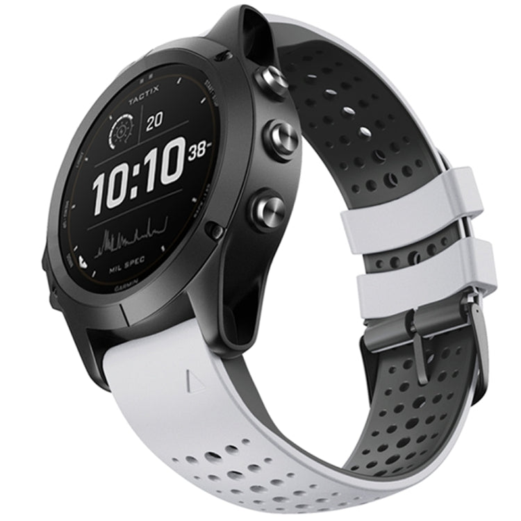 Silicone watch strap with round-hole perforations, white band and quick-release ends on black watch