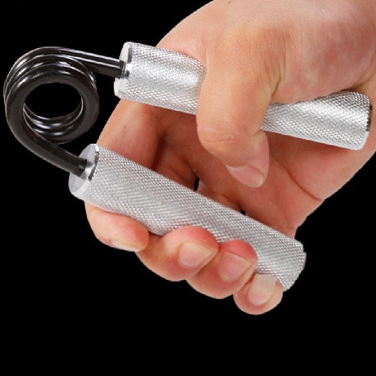 Wrist strength trainer in hand with black spring and silver mesh grips