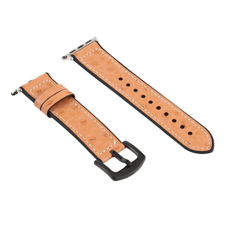 Tan leather watch band with metal buckle clasp and pin holes