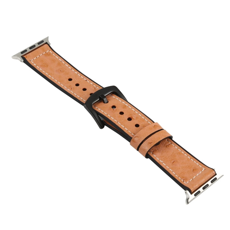 Tan leather watch band with black buckle clasp and pin holes