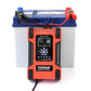 Battery charger connected to a blue lead-acid battery with red and black clamp leads.