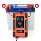 Battery charger connected to a blue lead-acid battery with visible red and black cables.