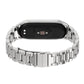 Stainless steel watch band with silver three-bead links, underside view of tracker
