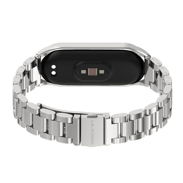 Stainless steel watch band with silver three-bead links, underside view of tracker