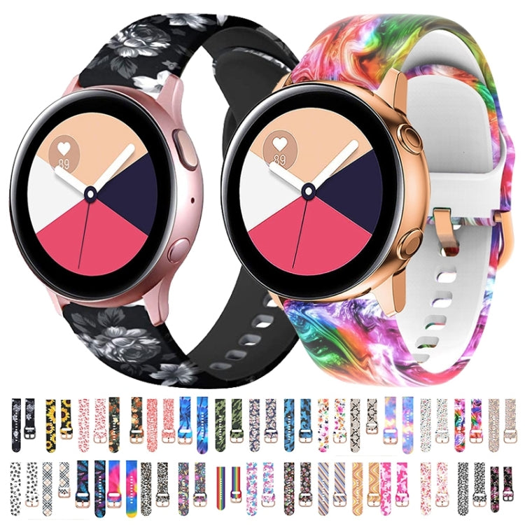 Two silicone watch bands: black floral and rainbow swirl, shown together