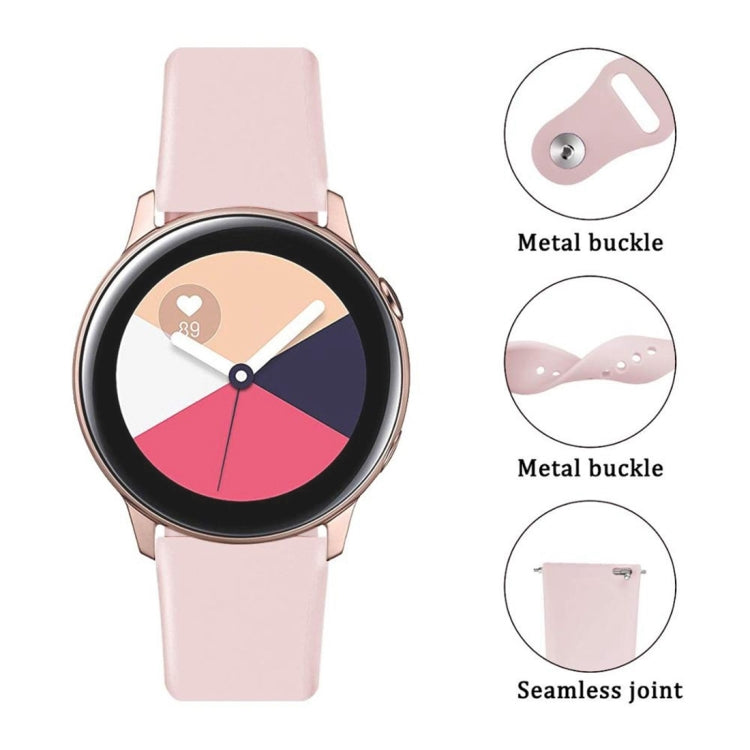 Pink silicone watch strap showing metal buckle and seamless joint
