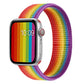 Rainbow woven nylon watch band with purple trim and metal pin ends