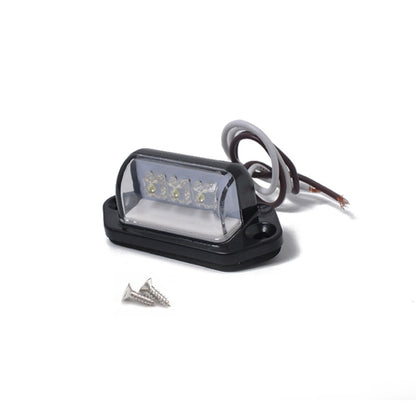 Black trailer rear license plate light with clear lens, 3 LED boards, and wire leads