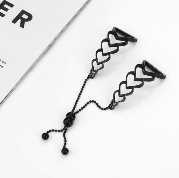 Black metal heart-link watchband bracelet with chain and three dangling beads.
