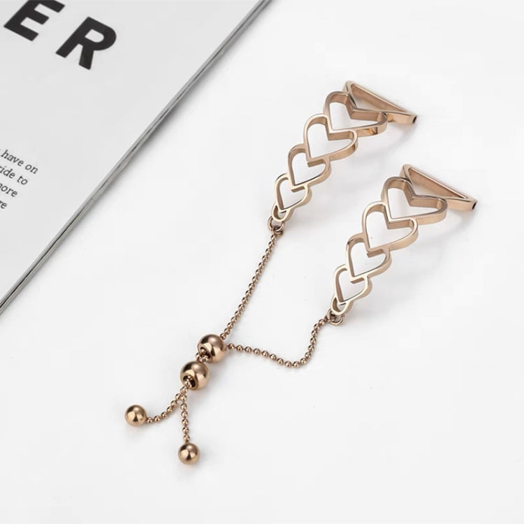 Rose gold heart-link watchband bracelet with chain and three dangling beads.
