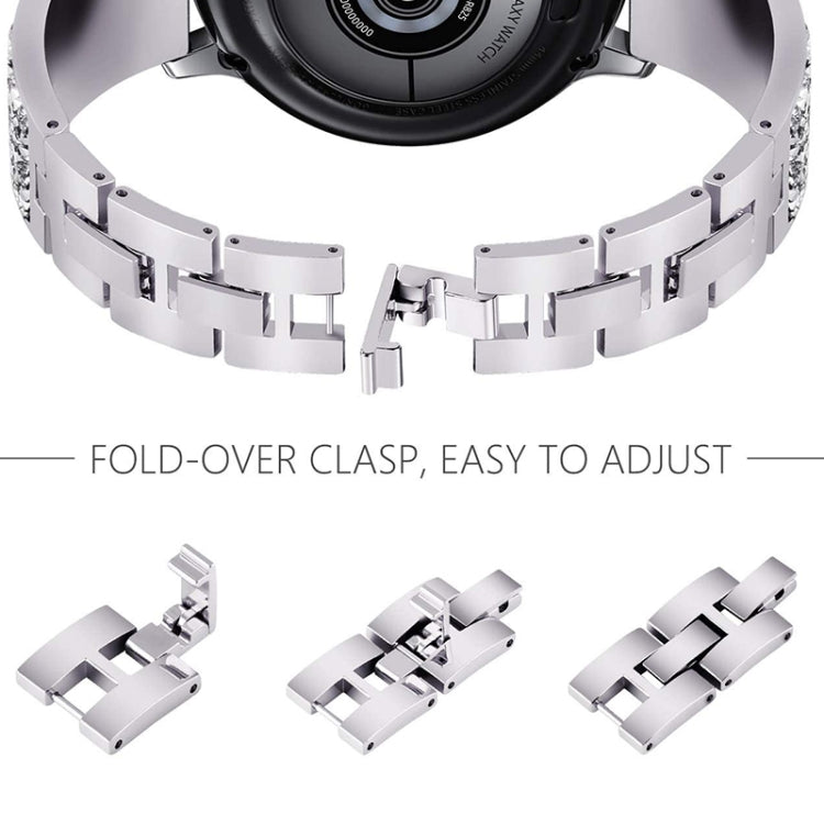 Silver metal watch band close-up with fold-over clasp and removable links