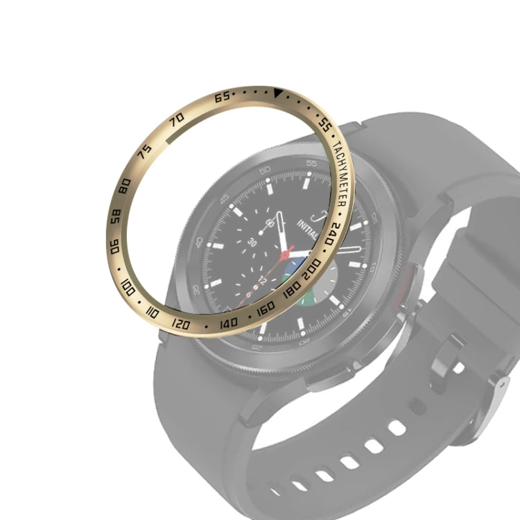 Smartwatch bezel ring with gold tone and black minute markings, on gray sport strap