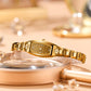 Gold tone women's quartz bracelet watch with rectangular bezel and gold link band