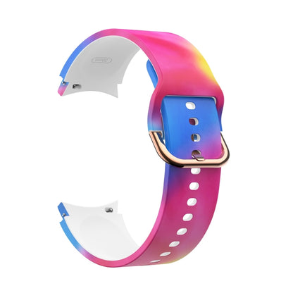 Rainbow tie-dye silicone smartwatch strap with rose-gold buckle and white pin holes
