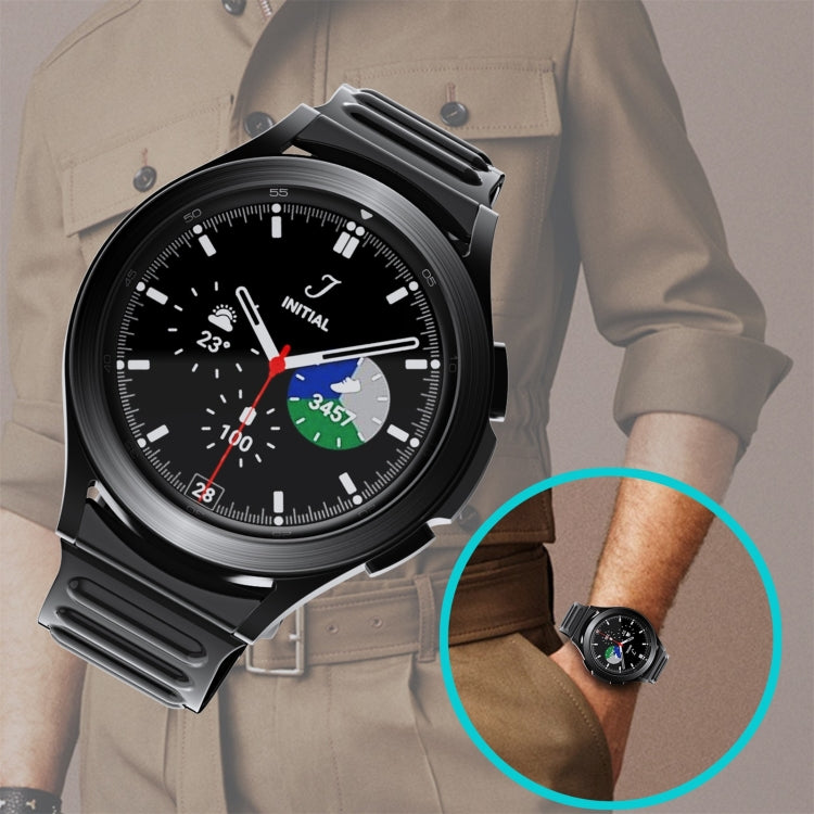 Black silicone watchband on wrist, paired with a round dark watch face.