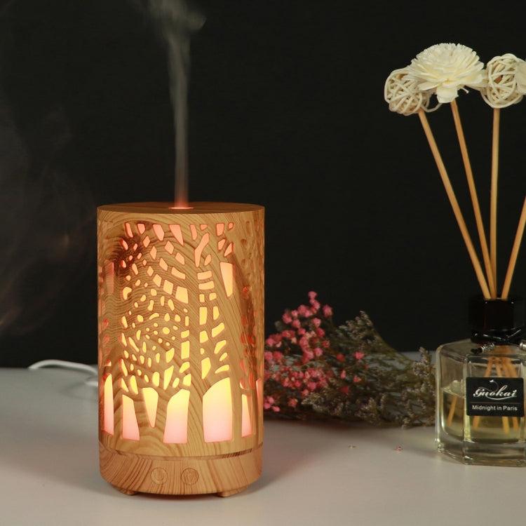 Wooden essential oil humidifier with tree cutout, orange LED glow, mist vapor