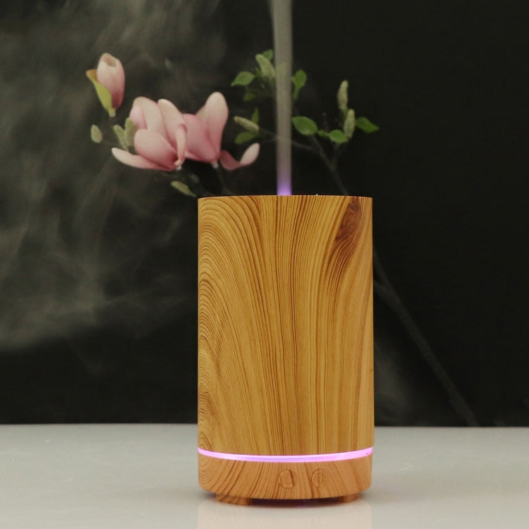 Wooden essential oil humidifier with light wood body, purple LED ring, mist vapor