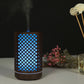 Wooden essential oil humidifier with blue grid cutouts, mist vapor