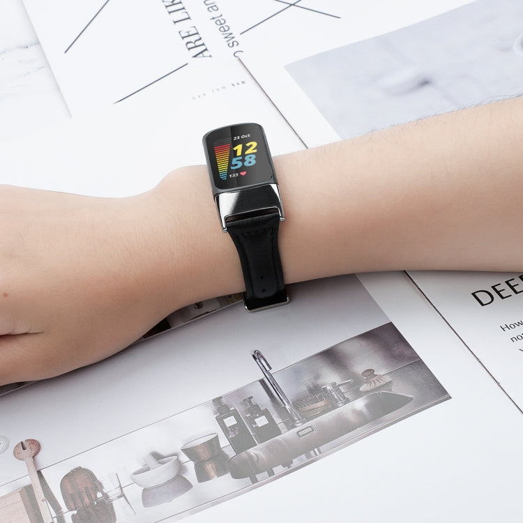Black leather watchband with metal buckle on smartwatch on wrist