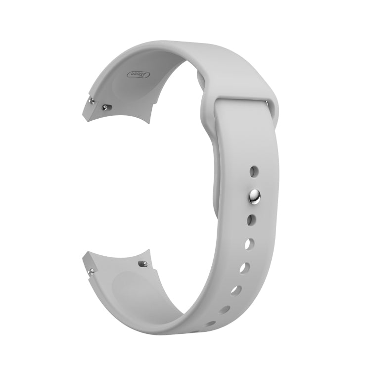 White silicone watch band with reverse buckle and adjustment holes, shown on wrist.
