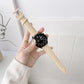 Leather watchband with beige leather strap, perforated holes, stitched edges, metal buckle