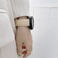 Beige leather watch strap with perforations and buckle, shown on a wrist with watch case.