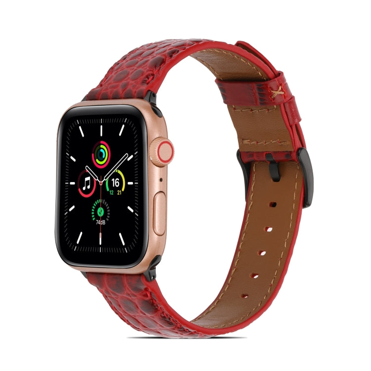 Crocodile-texture leather watch band, red with tan underside and stitched holes.