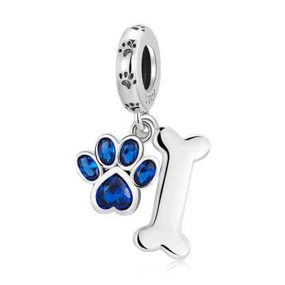 Sterling silver dog paw and bone pendant charm with blue CZ stones and loop bail
