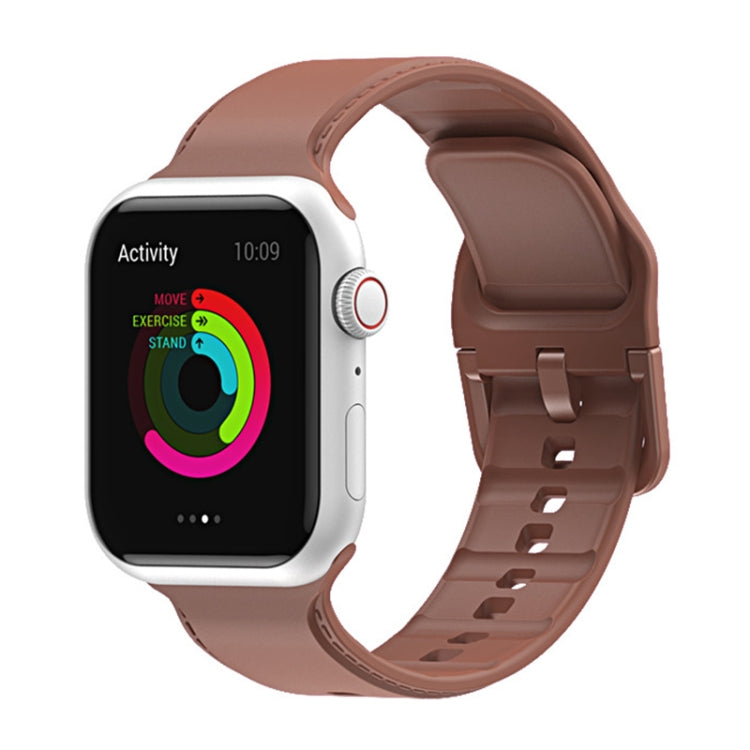 Brown silicone watch band with perforated strap and clasp for Apple Watch.