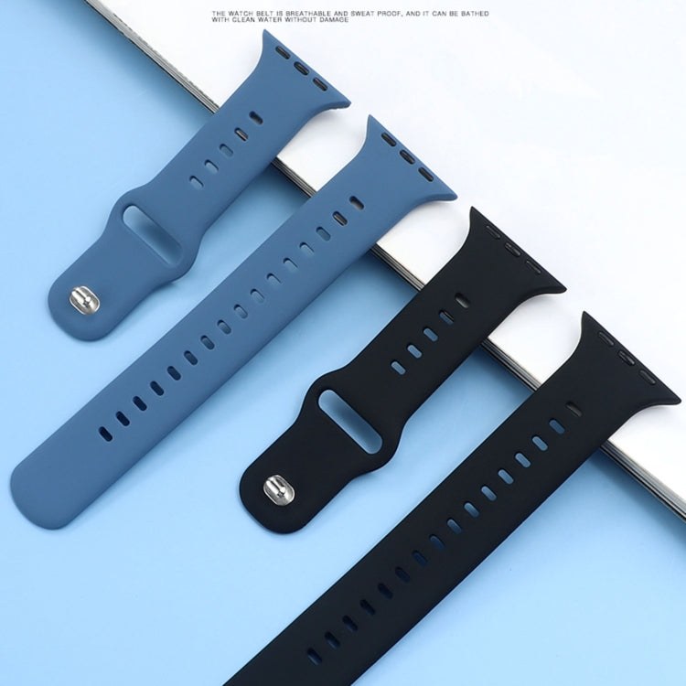 Multiple liquid silicone watchbands in blue and black tones with perforation holes.