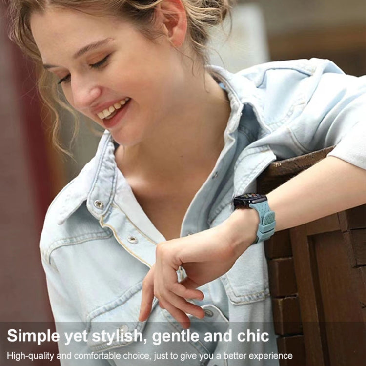 Woman wearing a teal braided silicone watch band with smartwatch on her wrist
