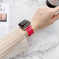 Transparent jelly Apple Watch band on wrist, pink-red gradient with metal clasp
