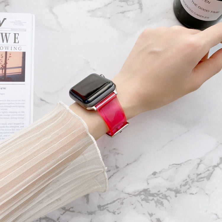 Transparent jelly Apple Watch band on wrist, pink-red gradient with metal clasp
