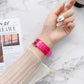 Transparent jelly Apple Watch band on wrist, magenta pink with metal buckle