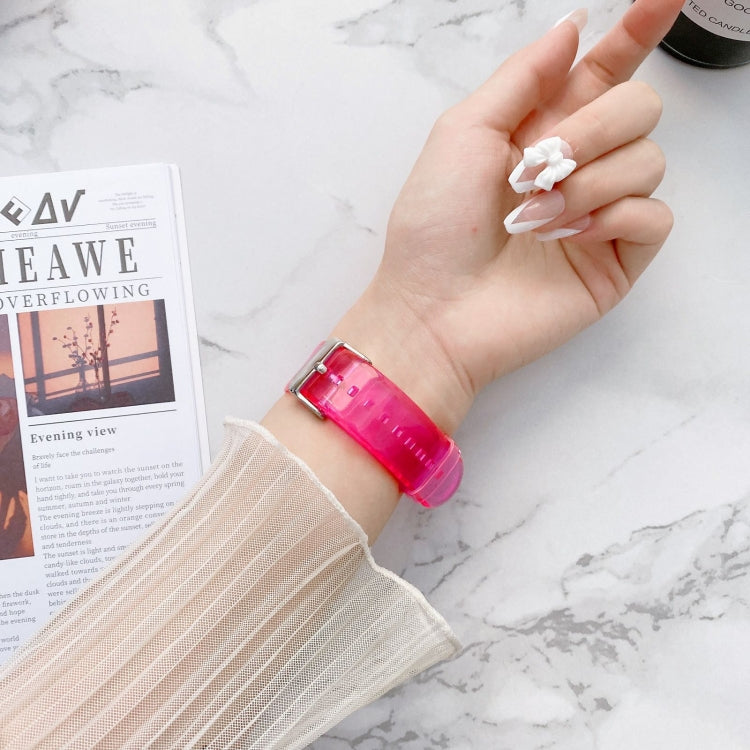 Transparent jelly Apple Watch band on wrist, magenta pink with metal buckle
