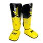 Yellow and black shin and ankle boxing leg guards with instep strap closure