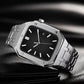 Silver metal watch with black dial and integrated link bracelet, angled close view