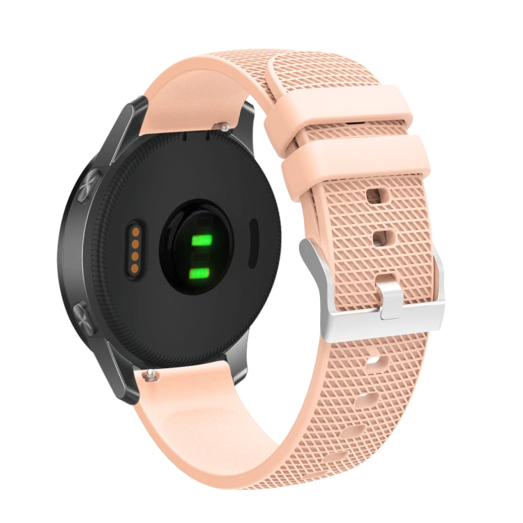 Silicone watch strap with textured pockmarked surface and silver buckle, peach band