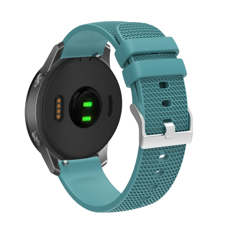 Teal silicone watch strap with silver buckle and pockmarked perforated band