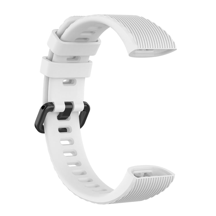 White silicone watch strap, clasp side and adjustment holes visible