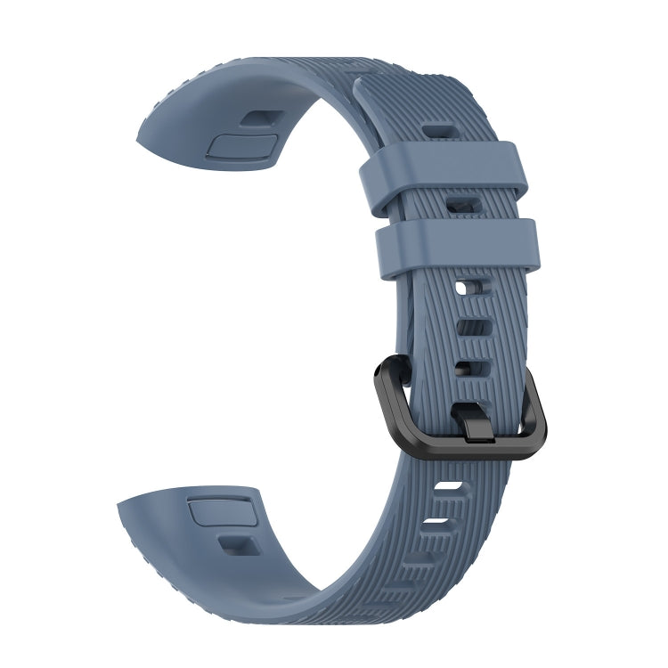 Blue silicone watch strap with ridged texture and adjustable buckle